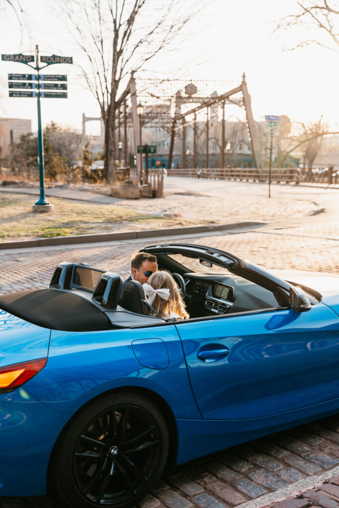 photo of couple sitting in sports car at parking ramp near St. Anthony Main, Minneapolis. 